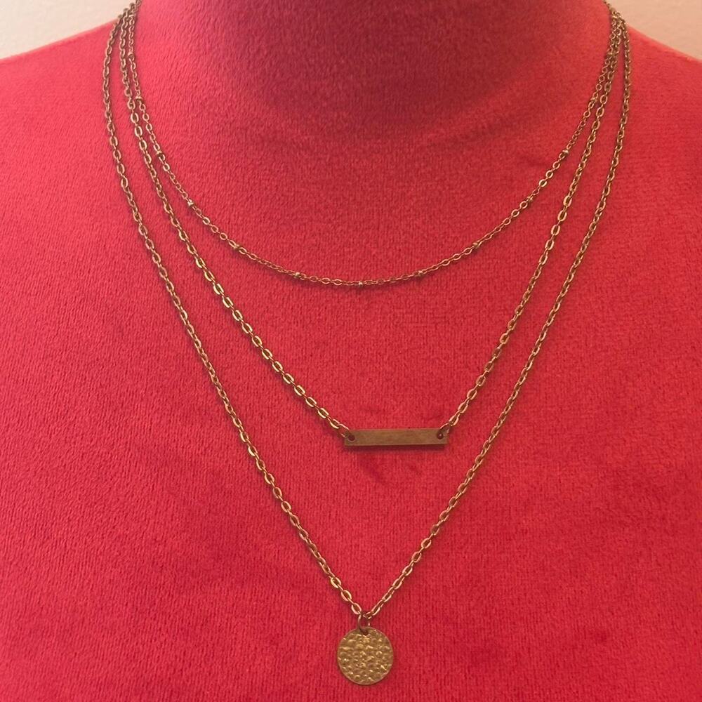Layered gold necklace with a